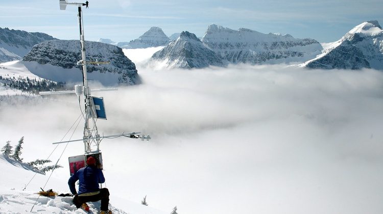 Snowy mountain range under clear winter sky